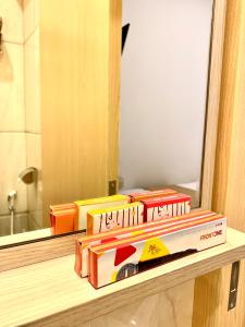 a pile of food sitting on a counter in front of a mirror at Front One Cabin Sunter in Jakarta +2 photos