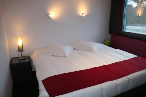 Uma cama ou camas num quarto em Hotel Carpinus