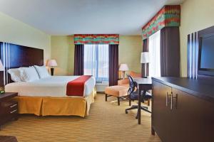 a hotel room with a bed and a desk at Holiday Inn Express Hotel & Suites Hamburg, an IHG Hotel in Hamburg