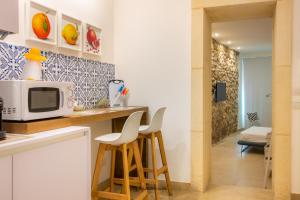 Кухня или мини-кухня в Archimede apartments
