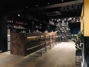 a bar with a row of stools in a restaurant at Hotel Nivki in Kyiv