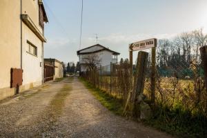 an empty road with a street sign on a fence at C'era una volta room in Case Nuove