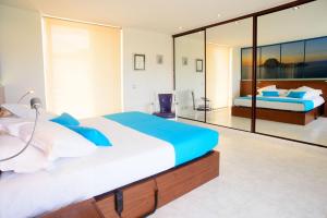 a large bedroom with two beds and a large mirror at Villa Melody in San Antonio Bay +14 photos