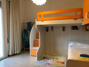 a childs bedroom with a bunk bed with an orange at Ca' Adriana in Lido di Jesolo