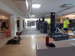 a man is walking in a gym with machines at SPAZIO-CONFORT-FITNESS in Piombino