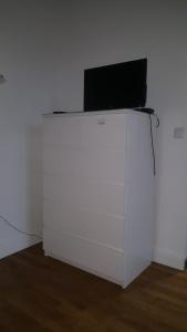 a white table with a laptop on top of it at Studio Cosy 2 adultes in Reims