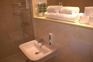 a bathroom with a sink and a shower and towels at Wine Hotel Cesarica in Međugorje +48 photos