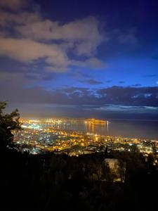 a view of a city lit up at night at Berg Apartments in Bar