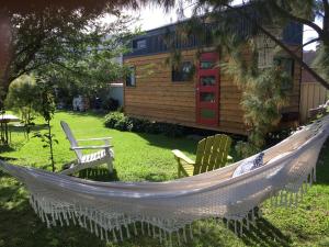 a hammock in a yard in front of a house at Tiny House in Woonona