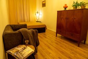 a living room with a couch and a dresser at Apartament Hygge Monte Cassino 4 in Szczecin
