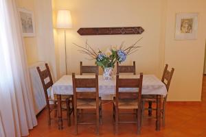 a dining room with a table with a vase of flowers at Glaros Home in Kato Daratso