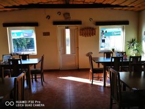 un comedor con mesas y sillas y una puerta en Restaurace a penzion u Jessyho, en Perná