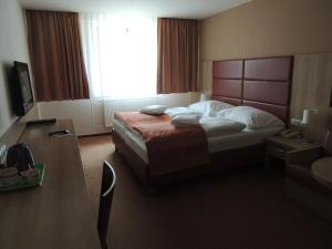 A bed or beds in a room at Hotel Club