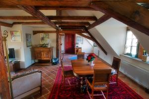 a dining room with a wooden table and chairs at Matsch - Plauens älteste Gastwirtschaft in Plauen