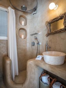 a bathroom with a sink and a shower at Margi Villas in Mikonos