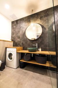 a bathroom with a sink and a washing machine at IRANYI Home - flat in the heart of downtown in Budapest