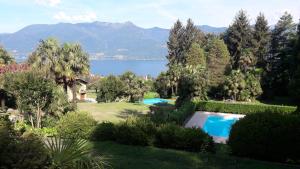 a house with a swimming pool and a view of the water at EV 37 in Germignaga