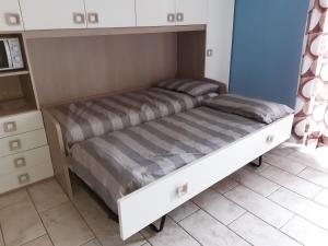 two beds in a small room with a cabinet at EV 37 in Germignaga +18 photos