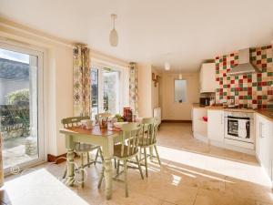 a kitchen and dining room with a table and chairs at Blueberry Cottage in Weymouth