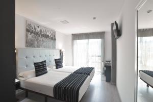 Een bed of bedden in een kamer bij Hotel Noia