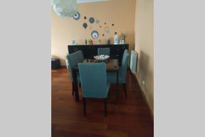 a dining room with a table and blue chairs at Diva Alojamento in Matosinhos +16 photos