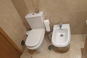 a bathroom with a white toilet and a bidet at Diva Alojamento in Matosinhos