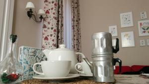 a table with a tea kettle and cups on it at Casa Pica in Naples