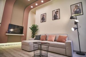ein Wohnzimmer mit einem Sofa und einem Flachbild-TV in der Unterkunft F4 Design Apartment- Budapest in Budapest