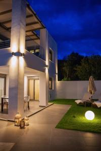 a house with lights on a patio at night at Adrianna Villa 4ppl in Bali