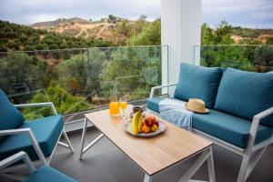 a table with a bowl of fruit on a balcony at Adrianna Villa 4ppl in Bali