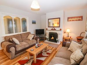 a living room with a couch and a fireplace at Upper Haven in Eyeries