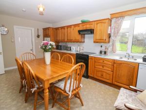 a kitchen with a wooden table and wooden cabinets at Upper Haven in Eyeries
