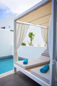 a bed in a room with a view of the ocean at Adrianna Villa 4ppl in Bali