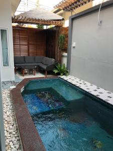 a swimming pool in the backyard of a house at Origin hua hin poolvilla in Hua Hin