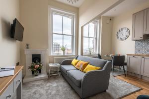 a living room with a couch and a table at Newly Converted Apartment Rowntree House Shambles in York
