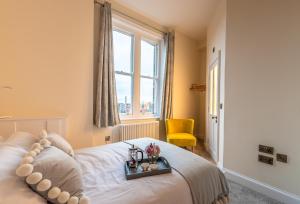 a bedroom with a bed with a tray on it at Newly Converted Apartment Rowntree House Shambles in York
