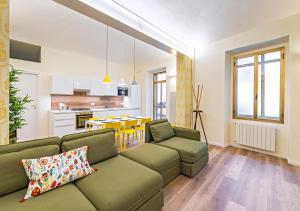 a living room with a couch and a kitchen at CITy TURIN HUB in Turin