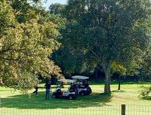 a group of people riding a golf cart in a park at Villa de Lujo en Campo de Golf - Costa Brava in Peralada