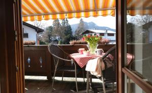 a table and chairs on a balcony with a view at Apartment 10 an der Rottach in Rottach-Egern