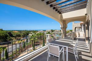a balcony with a table and chairs and a view at Shantiapartments in Vilamoura