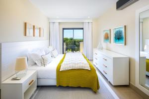 a bedroom with a bed with a yellow blanket at Shantiapartments in Vilamoura