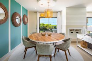 a dining room with a wooden table and chairs at Shantiapartments in Vilamoura