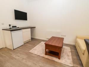 a living room with a couch and a table at The Old Stables in Belford