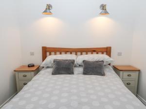a bedroom with a large bed with two night stands at The Old Stables in Belford