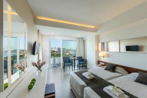 a bedroom with a bed and a living room at Melissi Beach Hotel & Spa in Ayia Napa