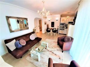 a living room with a brown couch and a table at Beach House - healthy, protected location! El Campello, Alicante, Spain in El Campello