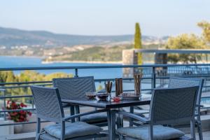 a table and chairs on a balcony with a view at Thealos Village in Lygia