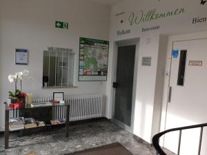 a lobby of a building with a sign on the wall at Horn Gästehaus in Leinfelden-Echterdingen