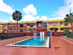 a swimming pool in front of a building at Casa Mar y Dunas in Parque Holandes