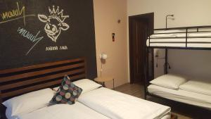 A bed or beds in a room at Mama Muh Self-Check-in